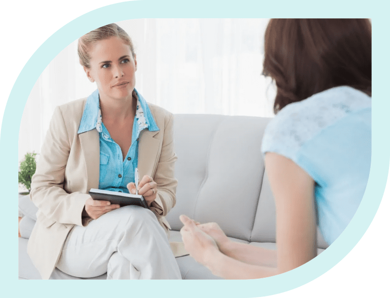 Therapist attentively listening to a patient during a counseling session.