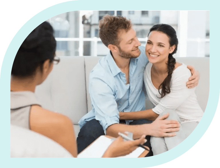 Couple happily embracing during a therapy session.